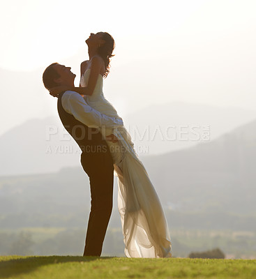 Buy stock photo Groom lifting bride, hug and wedding outdoor, sunshine with love and commitment in marriage. Man, woman and happiness, celebration and social event with mockup space, romance and life partner