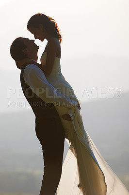 Buy stock photo Groom lift bride, wedding outdoor and hug with love for commitment in marriage. Man, woman and happiness, celebration and social event with trust and loyalty, romance and life partner in nature