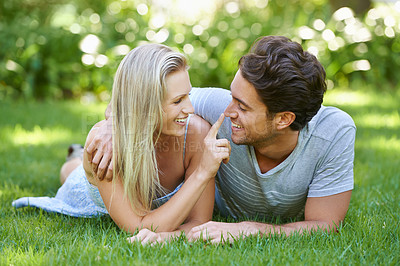 Buy stock photo Couple, relax in park and smile with love and commitment in healthy relationship. People on grass on date outdoor, nose touch and care with trust, partner and bond together for marriage and romance