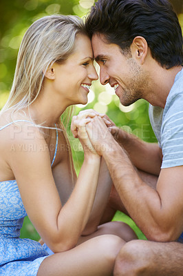 Buy stock photo Couple, forehead touch and smile in park with love and commitment in healthy relationship. People on date outdoor, happiness and care with trust, holding hands and bonding together for marriage