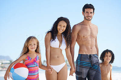 Buy stock photo Happy family, portrait and holding hands on beach for bonding, vacation or outdoor holiday weekend together. Father, mother and children smile with ball for summer break by the ocean coast in nature