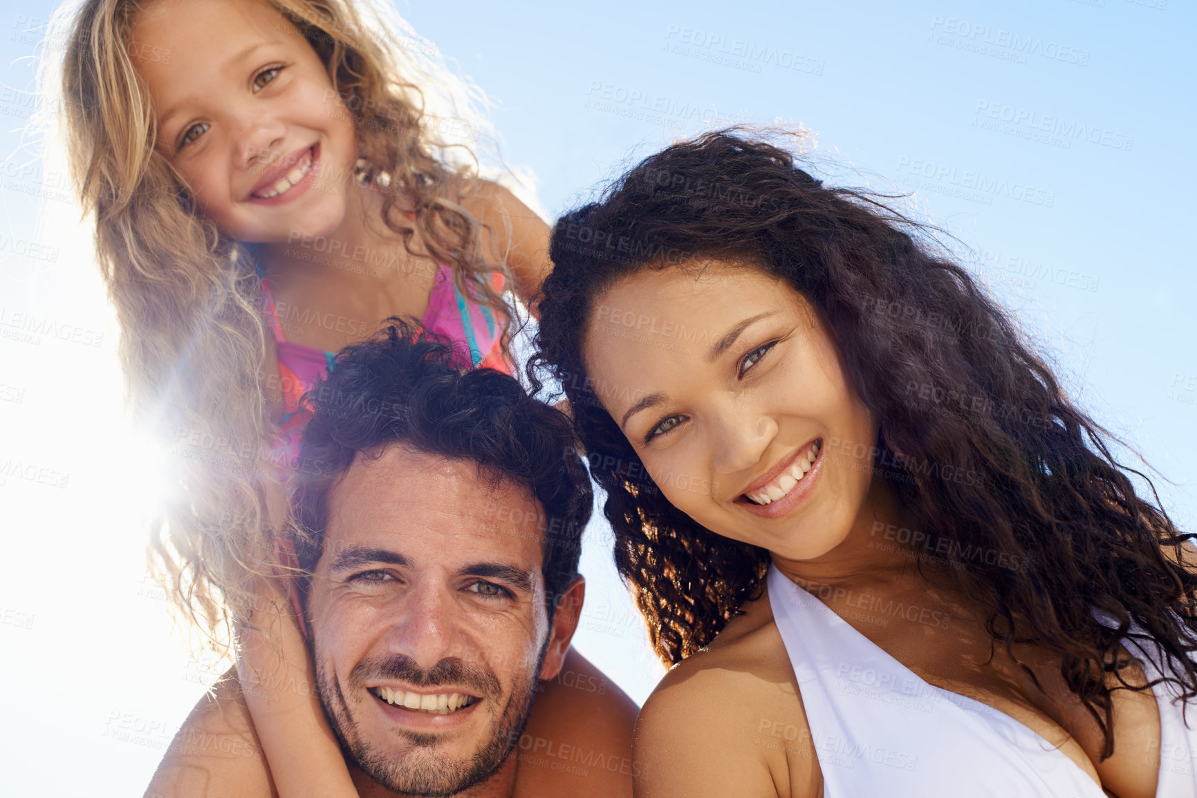 Buy stock photo Happy family, portrait and beach sun on bonding, vacation or outdoor holiday weekend together. Face of father, mother and child smile in hug for love, support or summer break by ocean coast in nature