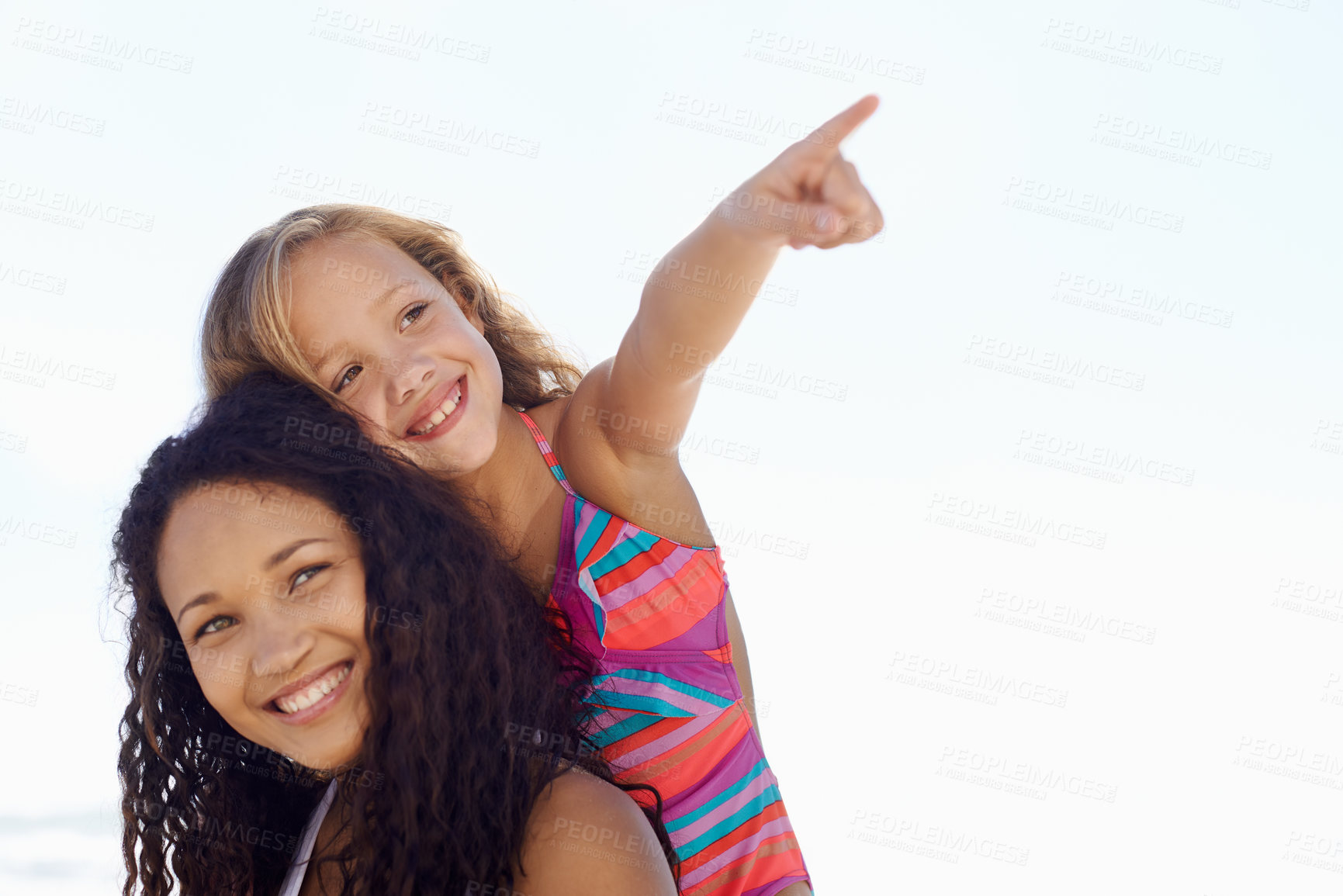 Buy stock photo Happy mother, child and pointing on piggyback at beach for exploring or sight on mockup space. Face of mom, daughter or kid smile for vision, adventure or looking in a distance on a sky background