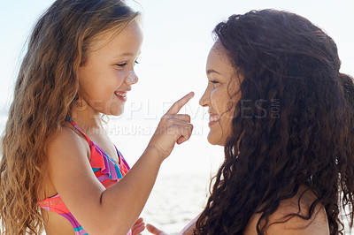 Buy stock photo Happy mother, girl and touching nose at beach for love, care or support for child or daughter in nature. Mom and cute young kid smile for poke, feel or sunscreen at ocean or outdoor sea by the coast
