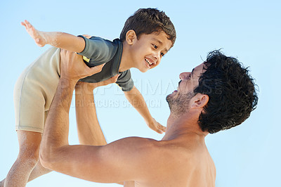 Buy stock photo A father raising his son up in the air