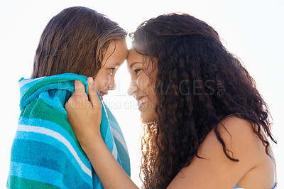 Buy stock photo Happy mother, child and towel on beach for warm, love or care in bonding, holiday or weekend together. Mom, kid or little girl smile at ocean coast to dry in sun for summer fun in outdoor nature