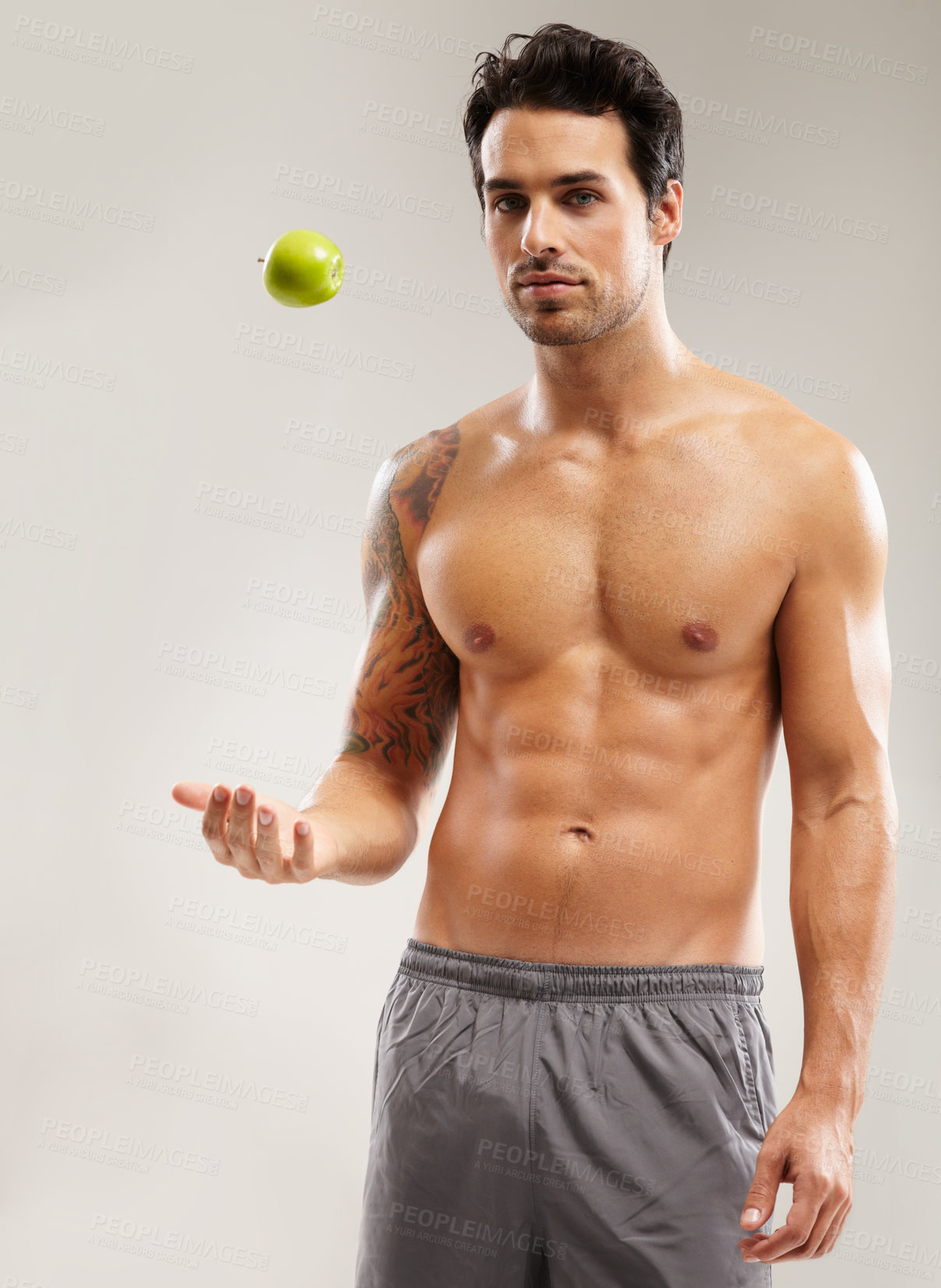 Buy stock photo Portrait, topless or man with apple, fitness or healthy diet for six pack abs in studio on gray background. Weight loss, throw or male person with a natural fruit for nutrition, vitamin c or wellness