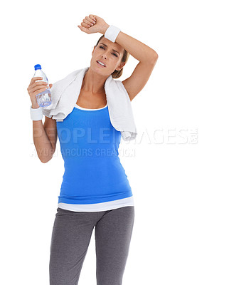 Buy stock photo Fitness, water bottle and tired woman in a studio on break for exercise, training or workout. Sports, weight loss and young female person with towel and hydration drink isolated by white background.