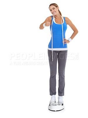 Buy stock photo Woman thumbs up, scale and measure tape in studio for fitness, weight loss or health goals, like or yes. Portrait of model with results, progress and workout or diet feedback on a white background