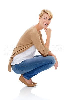 Buy stock photo A pretty young woman crouching in casual wear while isolated on a white background