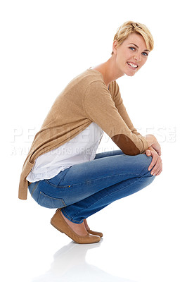 Buy stock photo Happy woman, portrait and sitting in casual fashion or pose isolated on a white studio background. Young female person, model or blonde smile with denim jeans or clothing in relax on mockup space