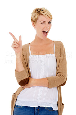Buy stock photo A pretty young woman pointing at copyspace and winking at you while isolated on white