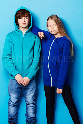 Buy stock photo Fashion, portrait and young girl and boy in a studio with a casual, cool and stylish outfit. Youth, friendship and portrait of teenager models posing together with trendy style by a blue background.
