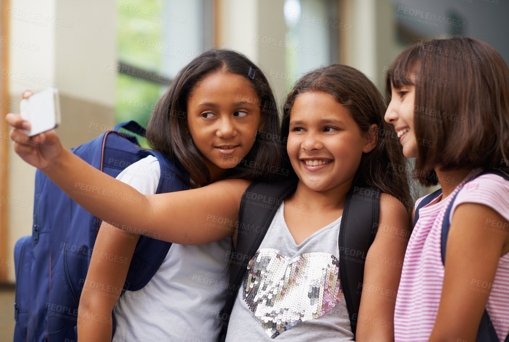 Buy stock photo Happy elementary school friends, children and selfie for fun educational memory in lobby together. Diversity, young students and group of girls smile for picture, digital photography and social media