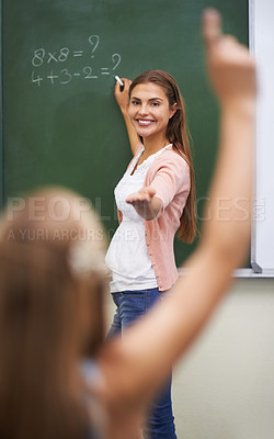 Buy stock photo Teacher, hands and children in classroom with answer, learning and discussion for education or math. Woman, school kids and happy with studying, knowledge and raised hand for scholarship or lesson