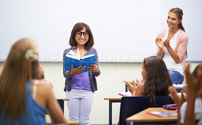 Buy stock photo A young girl doing prepared reading at the front of the class