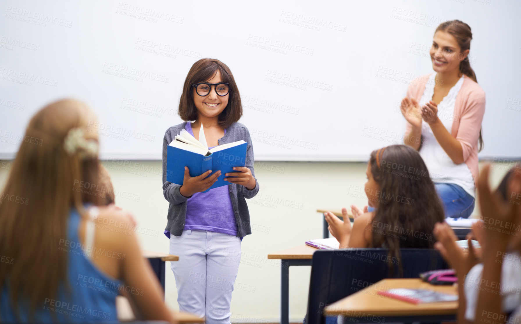 Buy stock photo A young girl doing prepared reading at the front of the class