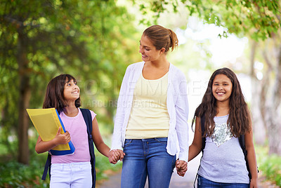 Buy stock photo Happy teacher, students and holding hands walking to school in outdoor park for support or responsibility. Woman, person or educator smile with learner, kids or young children with backpack in nature