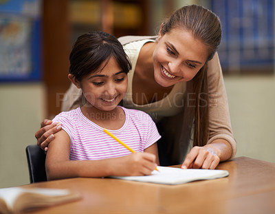 Buy stock photo School, study or learning with a student and teacher in a classroom together for writing or child development. Education, scholarship and teaching with a woman tutor helping a girl child in class
