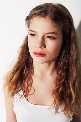 Buy stock photo An attractive young teenage girl standing against a white background