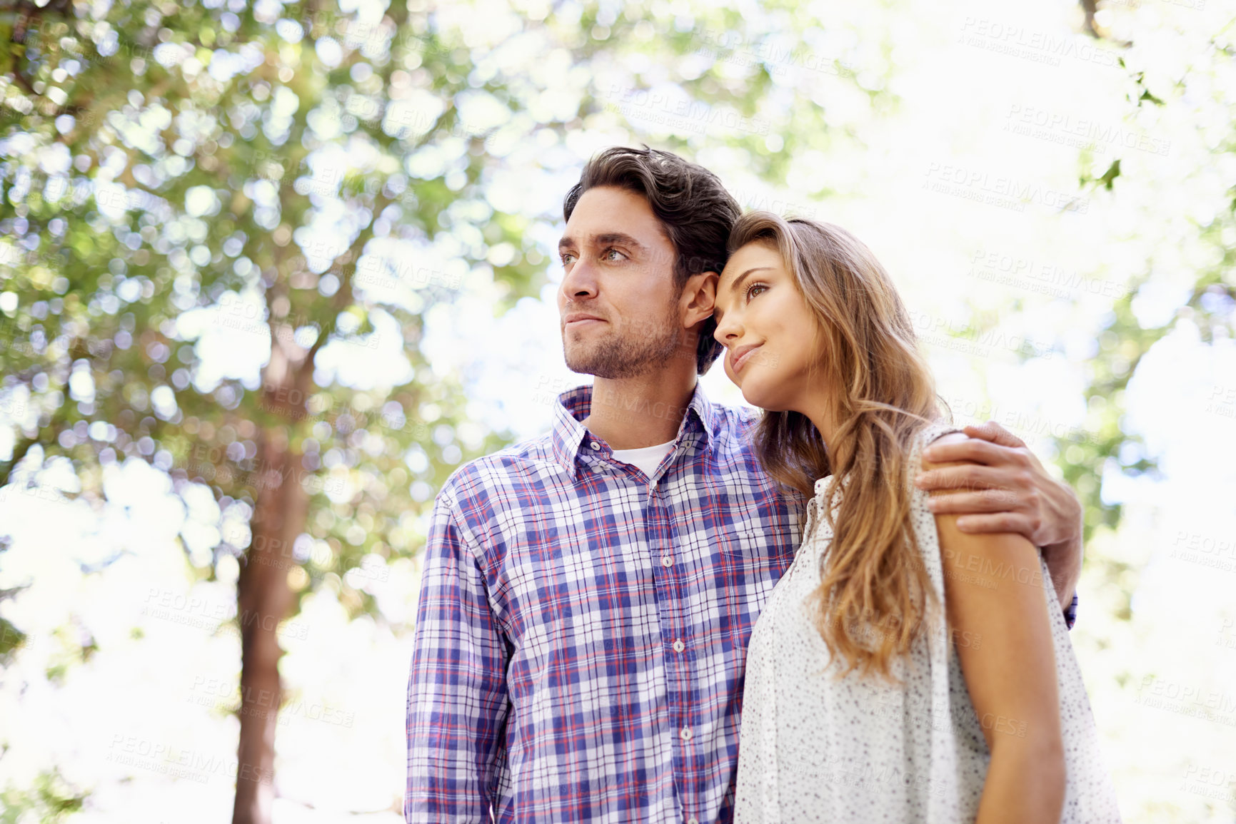 Buy stock photo Low angle, couple or hug on love date, valentines day or bonding in nature park, backyard or relax garden. Thinking, happy or embrace man and woman in trust, marriage security or partnership support