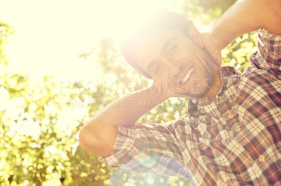 Buy stock photo Sun, man and portrait in an outdoor park with lens flare from sunshine in summer. Happy, smile and nature with a young person by trees feeling relax, calm and positive on a sunny day in a garden