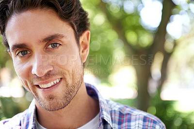 Buy stock photo Happy, portrait and man at a park for travel, relax or day off, cheerful and smile on nature background. Face, real and normal guy enjoying the weekend in a forest, content and satisfied in nature