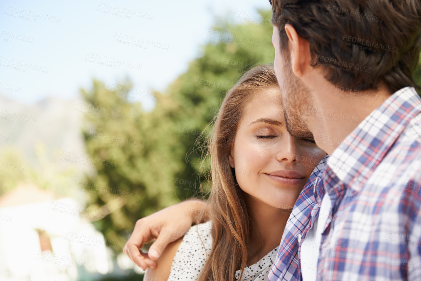 Buy stock photo Happy couple, trust or forehead kiss on love date, valentines day or romance bonding in nature, park or relax garden. Smile, woman or man kissing head in intimate security, hug or thank you support