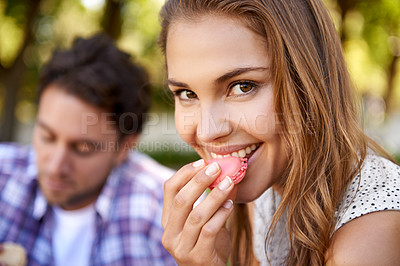 Buy stock photo Couple picnic, woman eating candy and portrait on grass with happiness, kindness and love on valentines date. Girl, macaroon and man together at nature park with food for bonding, romance and care