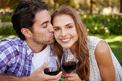 Buy stock photo Couple portrait, wine or cheek kiss on picnic date, valentines day or romance bonding in nature, park or garden. Smile, happy woman and man with alcohol drinks glass for love anniversary celebration