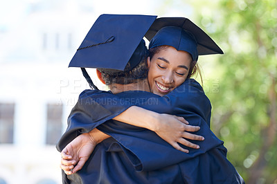 Buy stock photo Shot of two happy students embraceing in celebration on graduation day