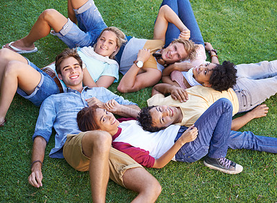 Buy stock photo Friends, group and grass or lying in circle in park or university relax, student peers or happy. Man, woman and portrait in nature or diversity on college campus or summer rest, weekend or connection