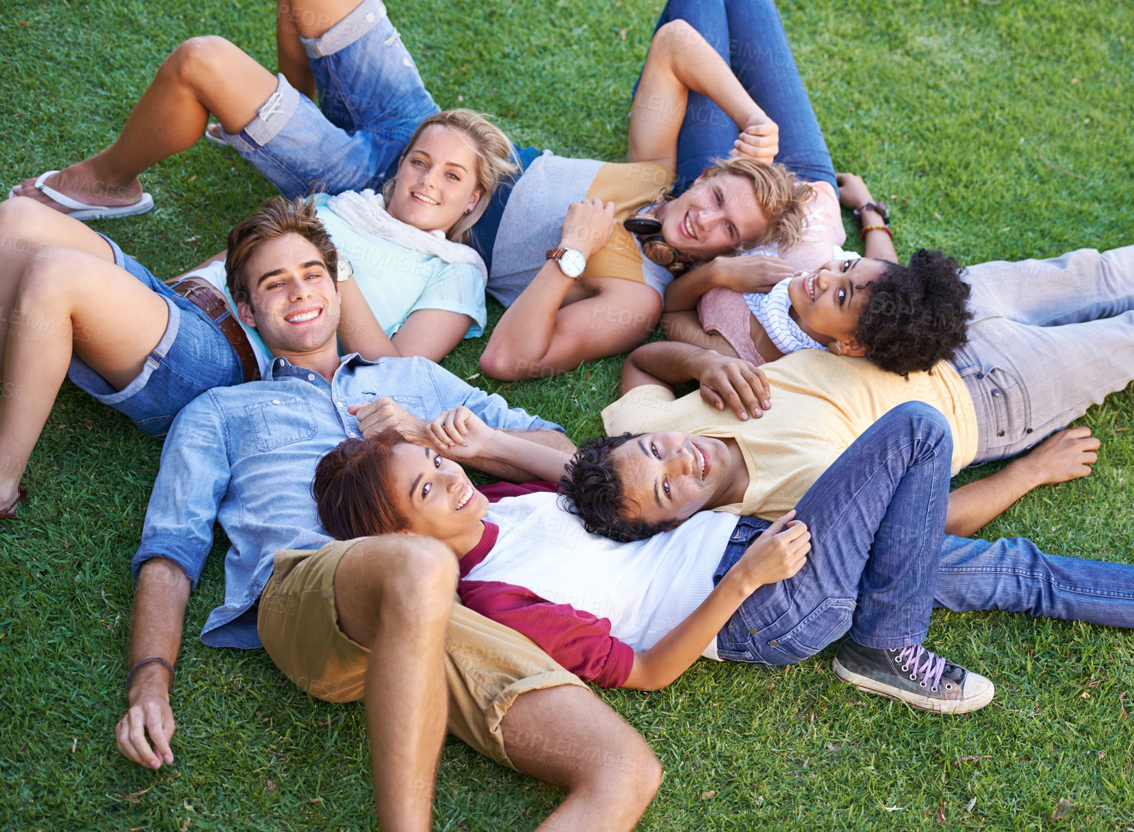Buy stock photo Friends, group and grass or lying in circle in park or university relax, student peers or happy. Man, woman and portrait in nature or diversity on college campus or summer rest, weekend or connection
