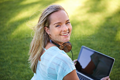 Buy stock photo College, portrait and student with laptop on grass working on research outdoor in park. University, campus and happy woman with computer, headphones and smile for writing notes on project for class