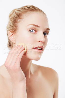 Buy stock photo Portrait of a blonde woman applying foundation