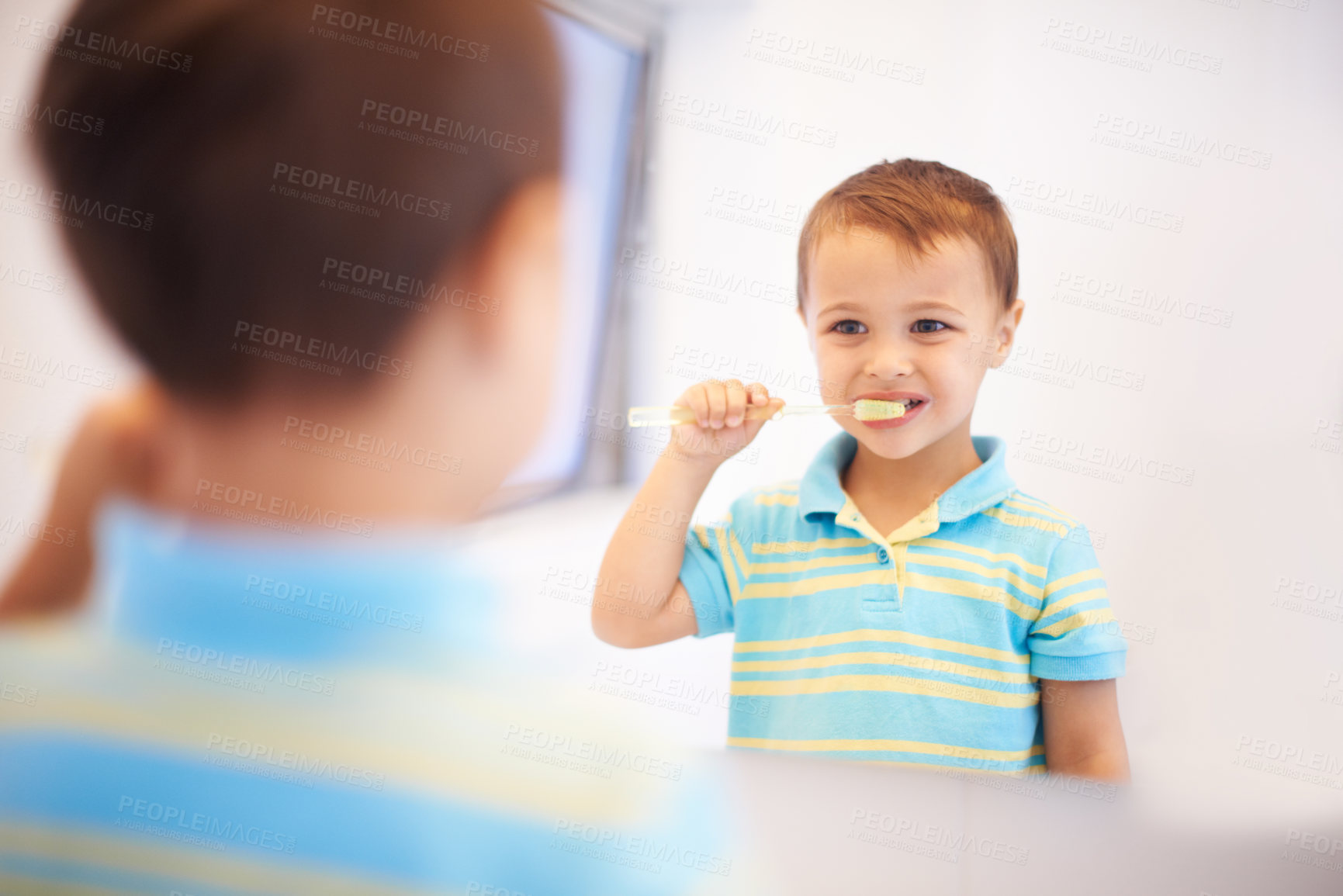 Buy stock photo Boy child, brushing teeth and mirror in bathroom for cleaning, hygiene or health for routine in home. Kid, toothbrush or reflection for dental wellness, smile or results in morning at family house