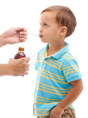 Buy stock photo Hands, medicine bottle and kid drink in studio, health or profile for spoon in mouth by white background. Boy, parent and liquid for healthcare, pharma product or helping sick child for immune system