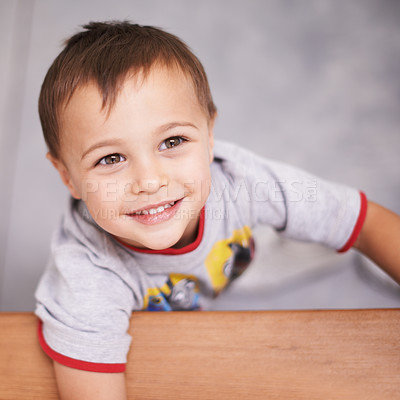 Buy stock photo Smile, cute and young kid in a studio with sweet, positive and good attitude for development. Happy, childhood and face aerial view of boy child with casual style isolated by white background.