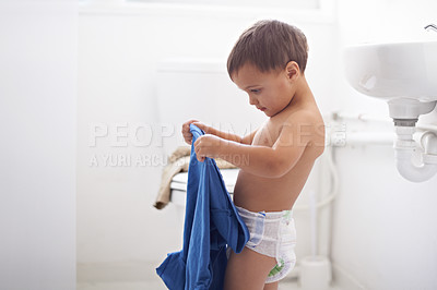 Buy stock photo Home, morning and child dressing with clothes and learning to style or change into shirt. Kid, toddler and development of independence from self care, routine and changing into outfit or garment