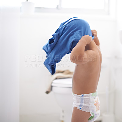 Buy stock photo Child, dressing and clothes in morning, home and learning to style or change into shirt in bathroom. Kindergarten, kid and development of independence in self care or changing into outfit for school