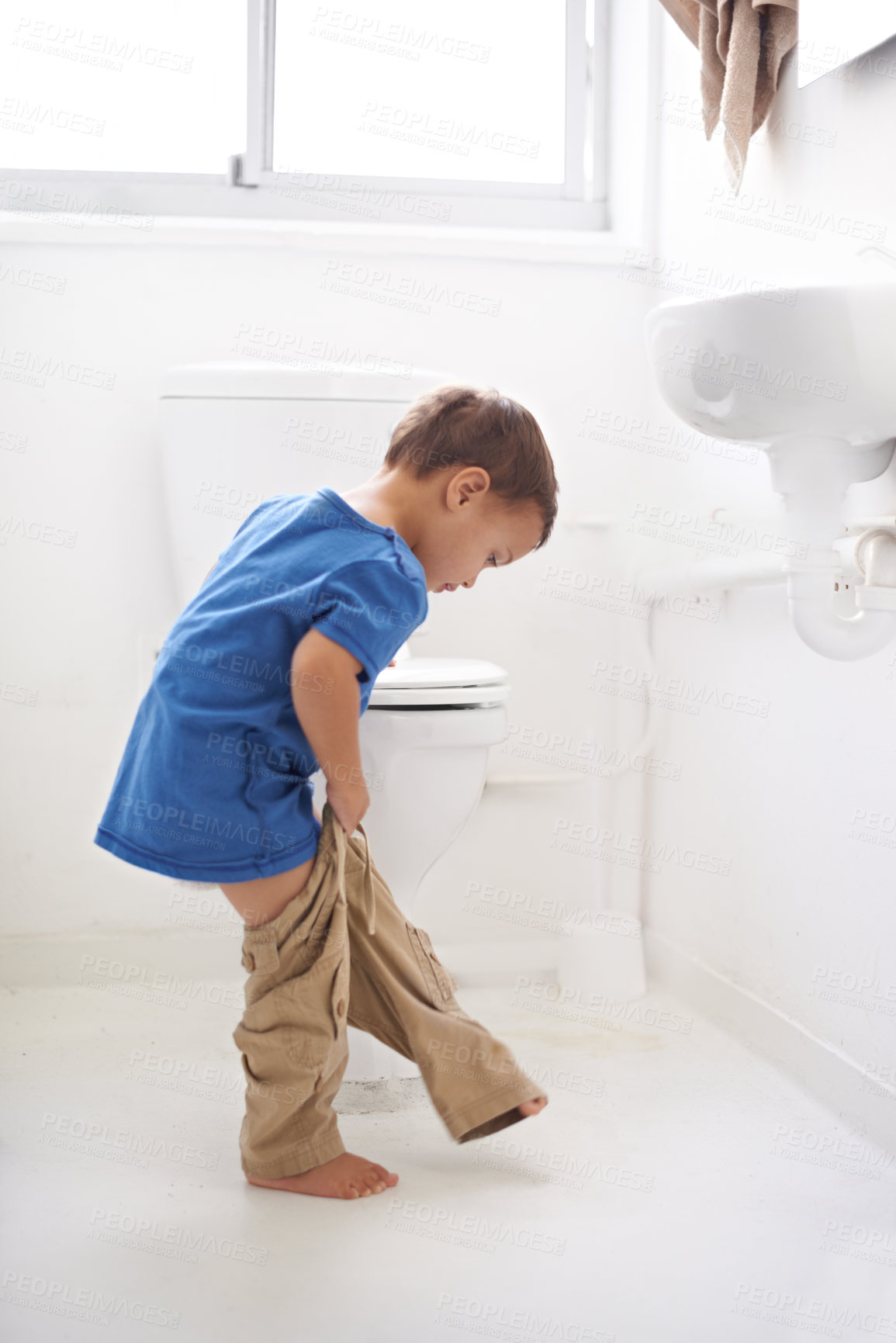 Buy stock photo Shot of a cute little boy in a bothroom