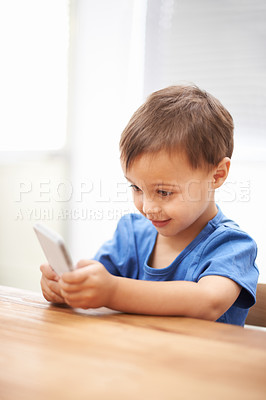 Buy stock photo Child, boy and relaxing on smartphone or texting, connection and playing games on technology. Male person, home and mobile application for social media, browsing website and scrolling on internet