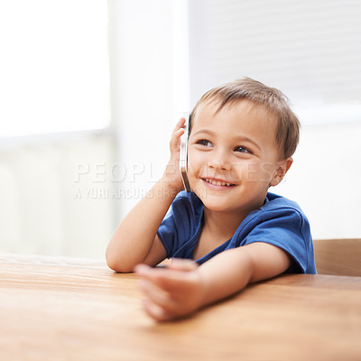Buy stock photo Toddler, boy and phonecall at home, happiness and communication with technology. Table, calling and conversation for learning, cellphone and excited for child development, mobile and digital