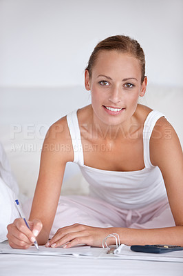 Buy stock photo Happy woman, portrait and writing on bed for budget planning, expenses or finance with documents at home. Female person smile with notebook or calculator for morning or financial checklist in bedroom