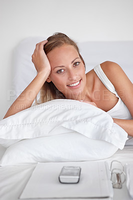 Buy stock photo Bed, relax and portrait of woman with pillow in home or wake up with happiness on vacation or holiday. Morning, bedroom and calm person with a smile for comfort in hotel, accommodation and phone