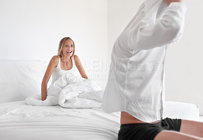 Buy stock photo Man, undress and woman in bed for relax morning as couple for romance, connection or marriage. Male person, partner and shirt in apartment or rest together in home for happiness wife, laugh or casual