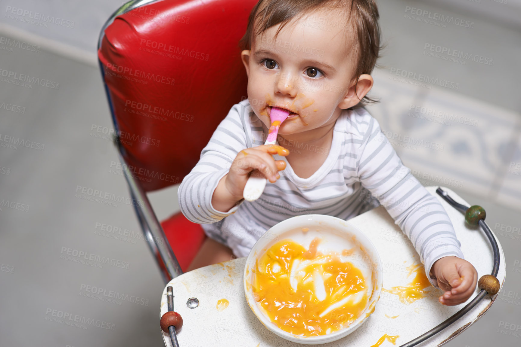 Buy stock photo Baby, high chair and food, nutrition and health for childhood development and wellness. Healthy, growth and girl toddler at home,  vegetable or fruit with hungry kid eating a meal  and spoon in mouth