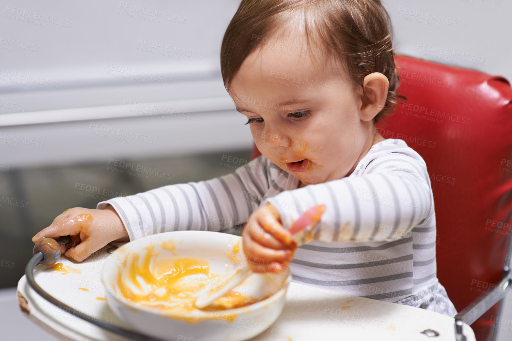 Buy stock photo Kid eating, high chair and food, nutrition and health for childhood development and wellness. Healthy, growth and toddler person at home, vegetable or fruit, hungry baby with lunch or dinner meal