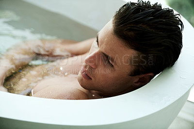 Buy stock photo Man, bath and water for relax in bathroom with thinking, wellness and contemplating with top view. Model, person and lying down in bathtub for self care, grooming and cosmetic routine with topless