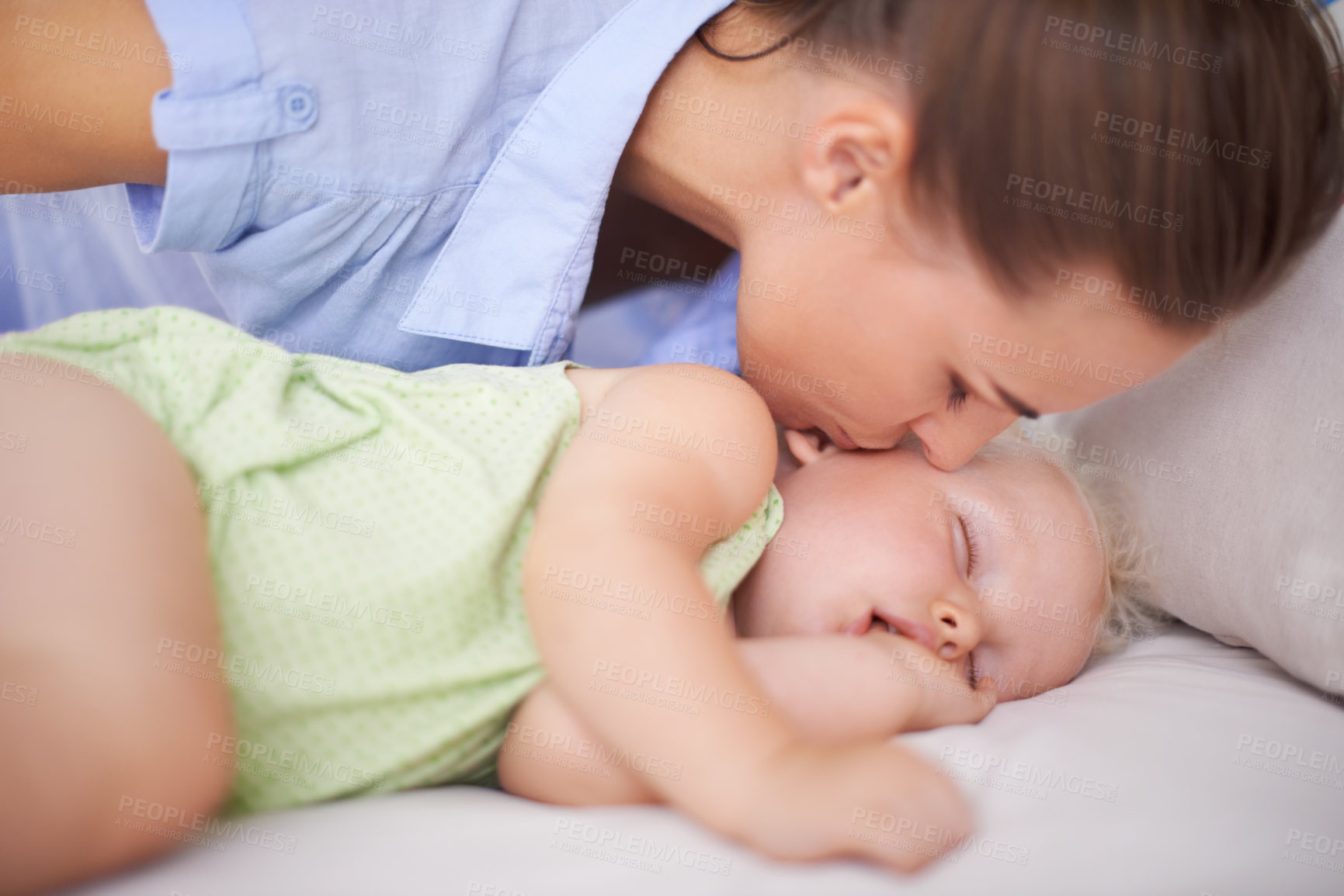 Buy stock photo Kiss, sleeping and mother with baby on bed for bonding, relax and sweet cute relationship. Happy, smile and young mom watching girl child, kid or toddler taking a nap in bedroom or nursery at home.